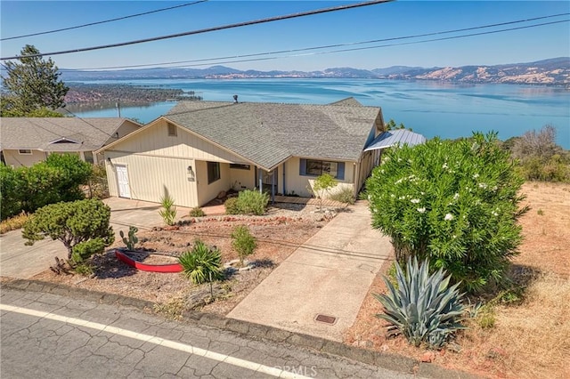 single story home with a water and mountain view