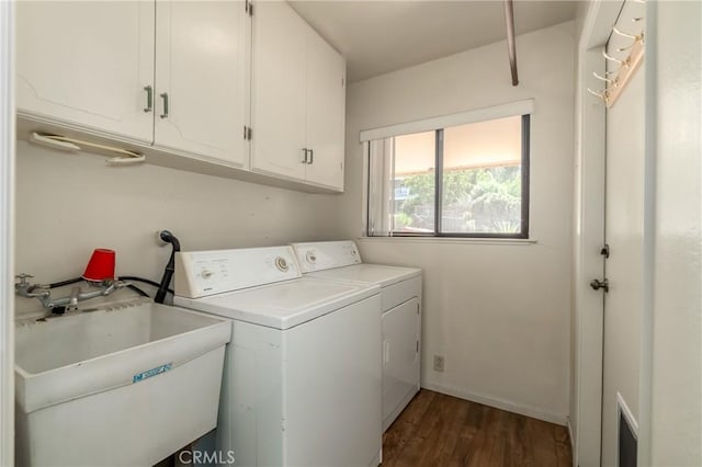 laundry area with dark wood-type flooring, sink, cabinets, and independent washer and dryer