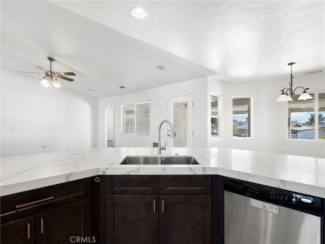 kitchen featuring stainless steel dishwasher, dark brown cabinets, ceiling fan with notable chandelier, sink, and hanging light fixtures