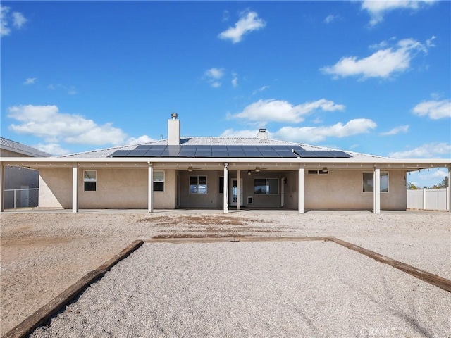 back of property featuring solar panels