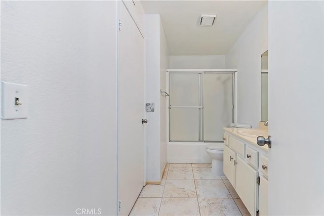 full bathroom featuring tile patterned flooring, vanity, enclosed tub / shower combo, and toilet