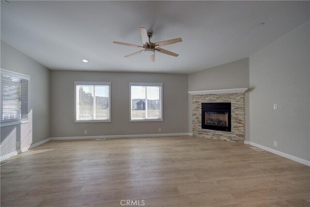 1592 Deer Canyon Rd, Arroyo Grande, CA 93420 - unfurnished living room with ceiling fan, light wood finished floors, baseboards, a stone fireplace, and recessed lighting