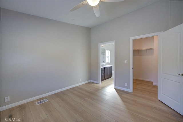 1592 Deer Canyon Rd, Arroyo Grande, CA 93420 - unfurnished bedroom featuring a walk in closet, light wood finished floors, baseboards, and a closet