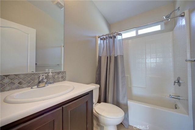 full bathroom featuring vanity, toilet, backsplash, and shower / tub combo with curtain