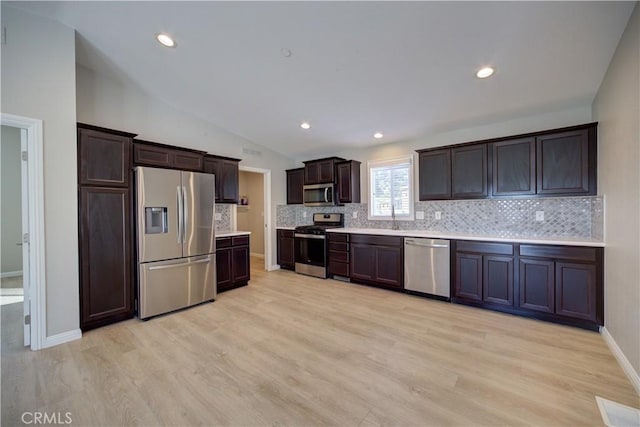 1592 Deer Canyon Rd, Arroyo Grande, CA 93420 - kitchen featuring stainless steel appliances, dark brown cabinets, light countertops, backsplash, and lofted ceiling