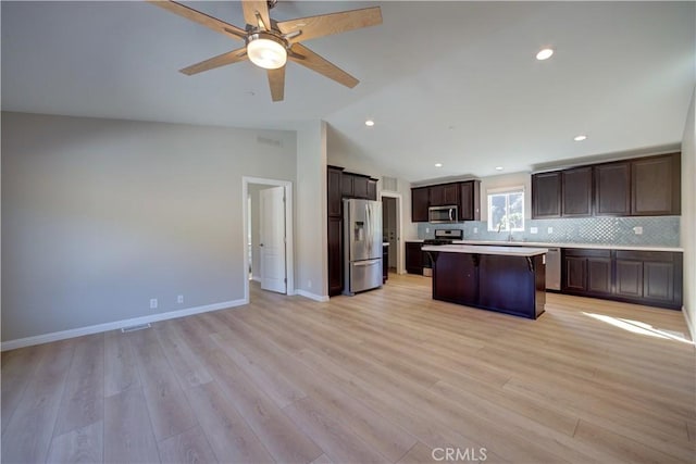 1592 Deer Canyon Rd, Arroyo Grande, CA 93420 - kitchen featuring stainless steel appliances, a kitchen island, dark brown cabinetry, a ceiling fan, and open floor plan