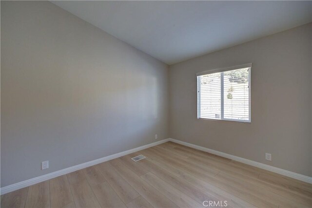 1592 Deer Canyon Rd, Arroyo Grande, CA 93420 - empty room with light wood-style flooring, baseboards, and vaulted ceiling