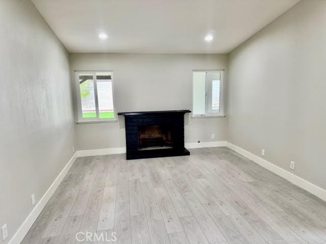 unfurnished living room featuring light hardwood / wood-style flooring