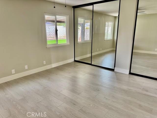 unfurnished bedroom featuring light wood-type flooring