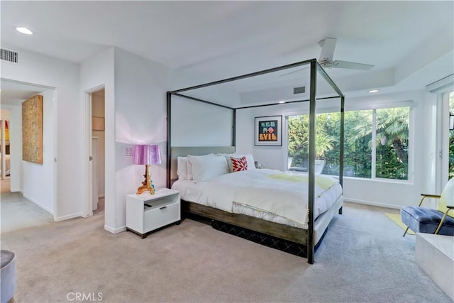 bedroom with ceiling fan and light carpet