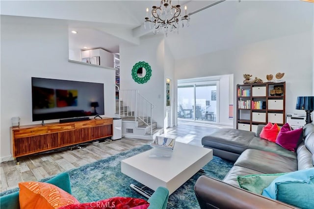 living room with beam ceiling, an inviting chandelier, and hardwood / wood-style flooring