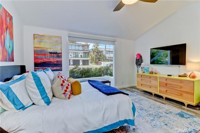 bedroom featuring ceiling fan, lofted ceiling, and hardwood / wood-style flooring