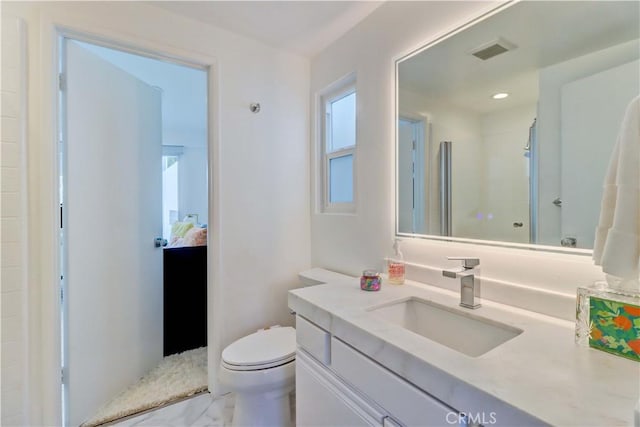 bathroom featuring toilet and vanity