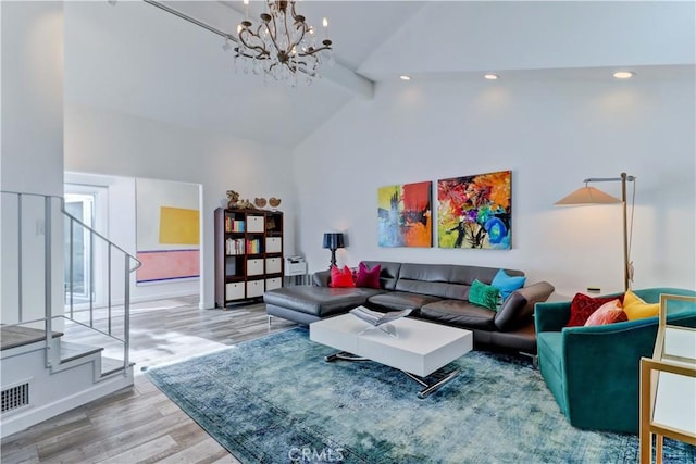 living room with a chandelier, light hardwood / wood-style floors, beam ceiling, and high vaulted ceiling