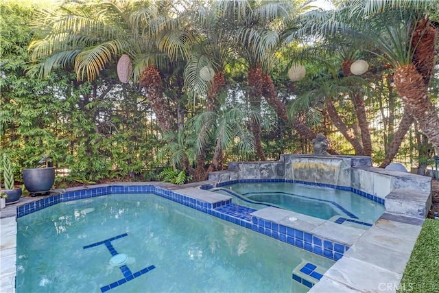 view of swimming pool with an in ground hot tub