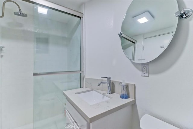 bathroom with walk in shower, vanity, and toilet