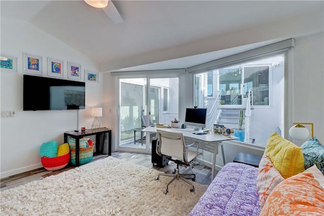 office featuring ceiling fan, vaulted ceiling, and light hardwood / wood-style flooring