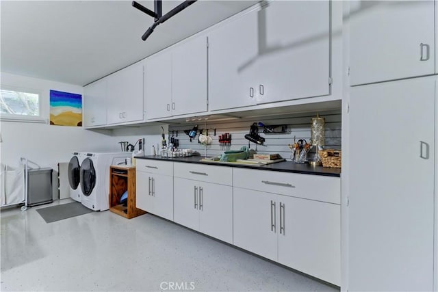 laundry area featuring washer and dryer and cabinets