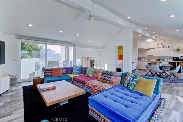 living room featuring light hardwood / wood-style floors, lofted ceiling with beams, and ceiling fan