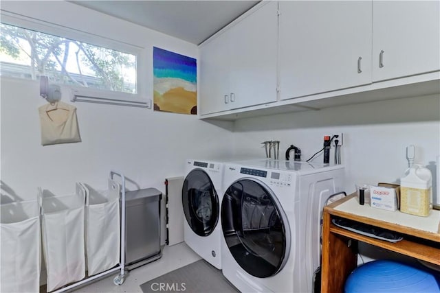 laundry area featuring cabinets and washer and dryer