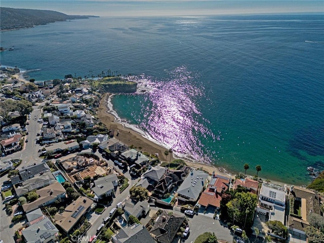 bird's eye view with a water view and a beach view