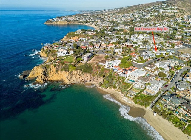 birds eye view of property with a view of the beach and a water view