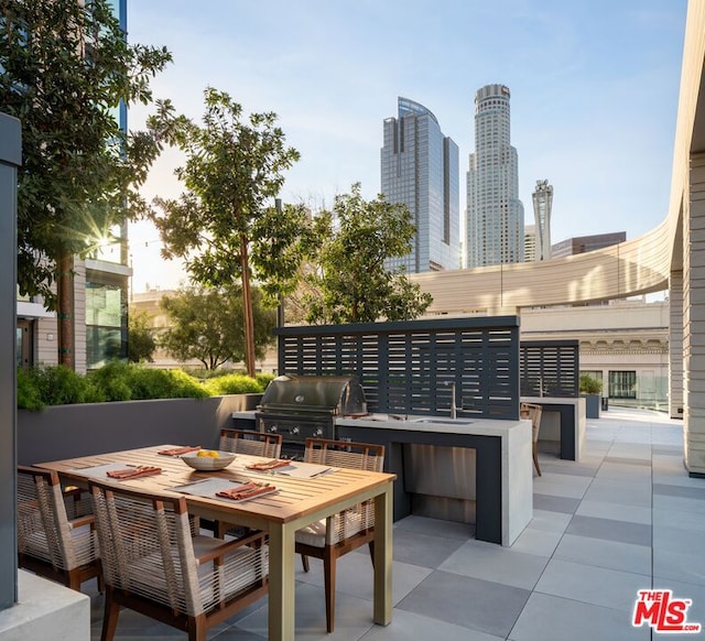 view of patio / terrace featuring a grill, sink, and exterior kitchen