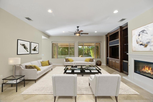 tiled living room featuring ceiling fan