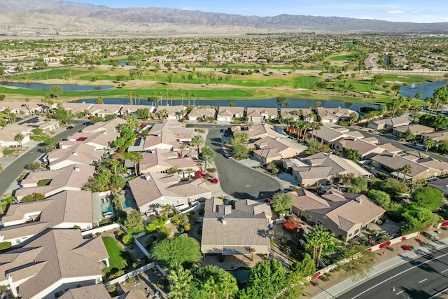 birds eye view of property with a water and mountain view