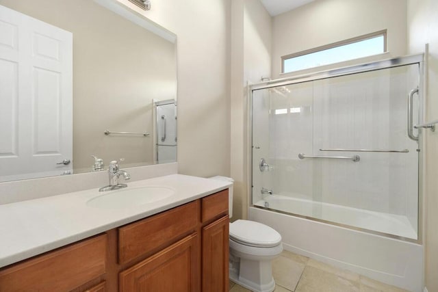 full bathroom featuring toilet, enclosed tub / shower combo, tile patterned flooring, and vanity