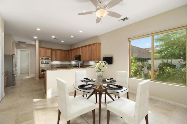 tiled dining area featuring ceiling fan