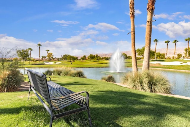 view of home's community featuring a lawn and a water view