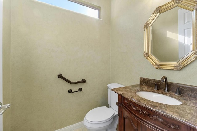 bathroom featuring toilet and vanity