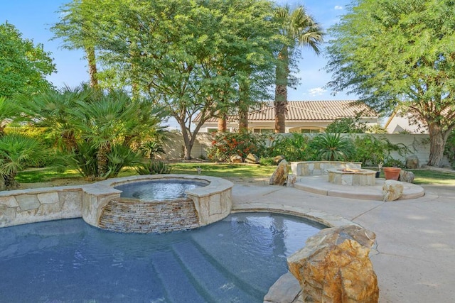 view of pool featuring a patio area and an in ground hot tub