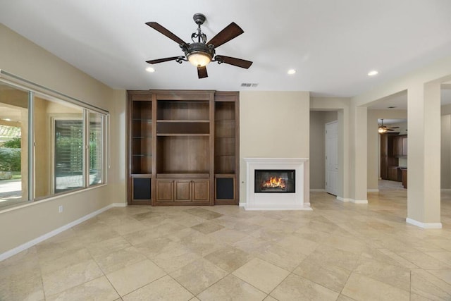 unfurnished living room with ceiling fan