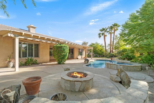 view of swimming pool with an in ground hot tub, a fire pit, and a patio