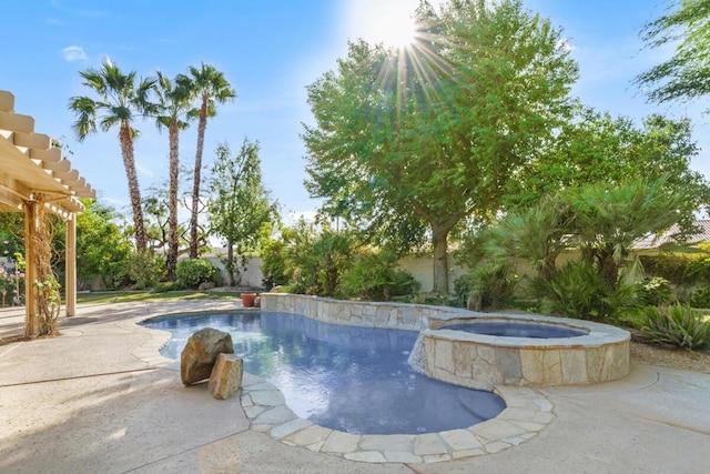 view of pool featuring a patio area and an in ground hot tub