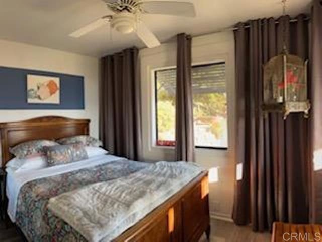 bedroom with ceiling fan and hardwood / wood-style floors