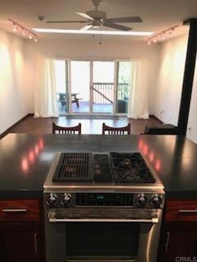 kitchen featuring ceiling fan, high end range, and rail lighting