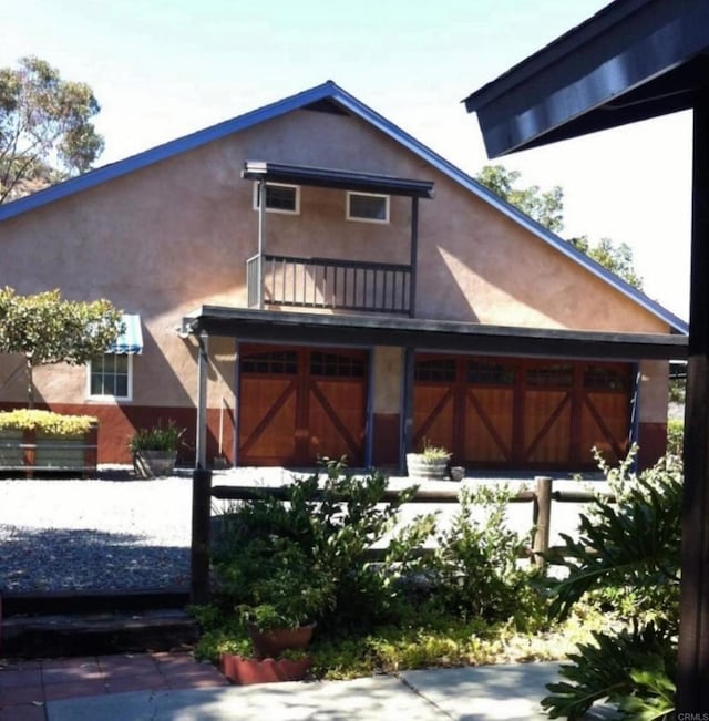 back of property featuring a balcony