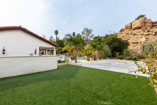 view of yard featuring basketball court