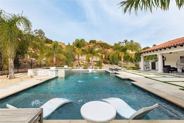 view of pool featuring ceiling fan and a patio area