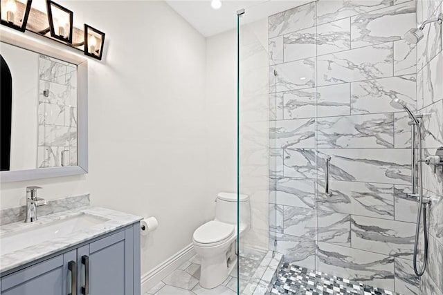 bathroom featuring vanity, toilet, and a shower with door