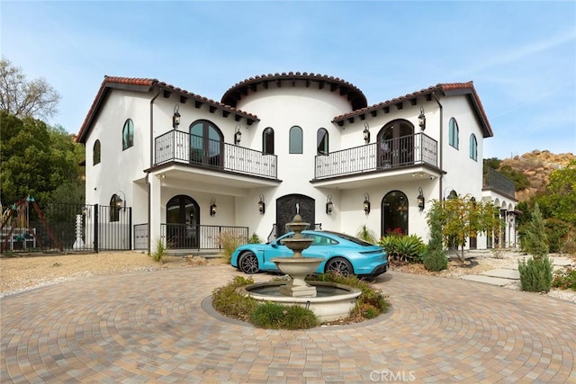 mediterranean / spanish-style house featuring a balcony