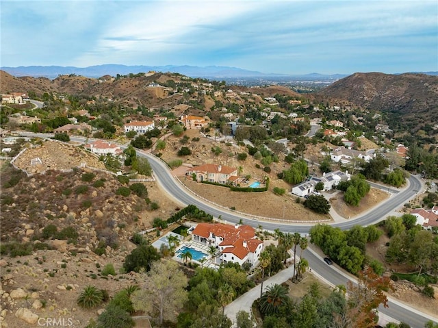 birds eye view of property with a mountain view