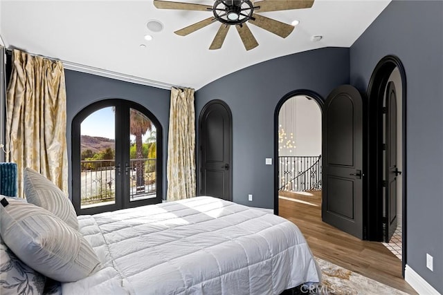 bedroom with french doors, light hardwood / wood-style flooring, ceiling fan, and lofted ceiling