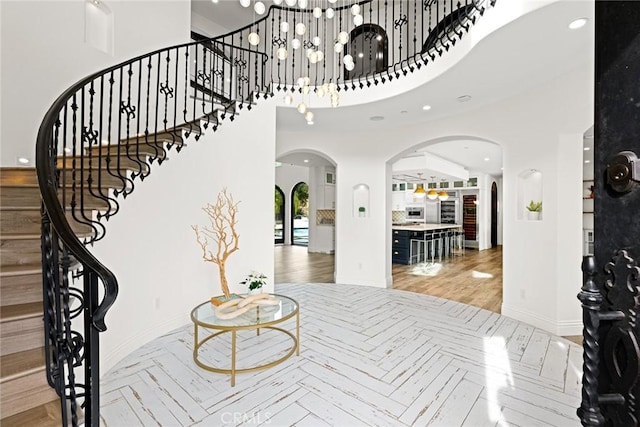 entrance foyer with wood-type flooring and a high ceiling