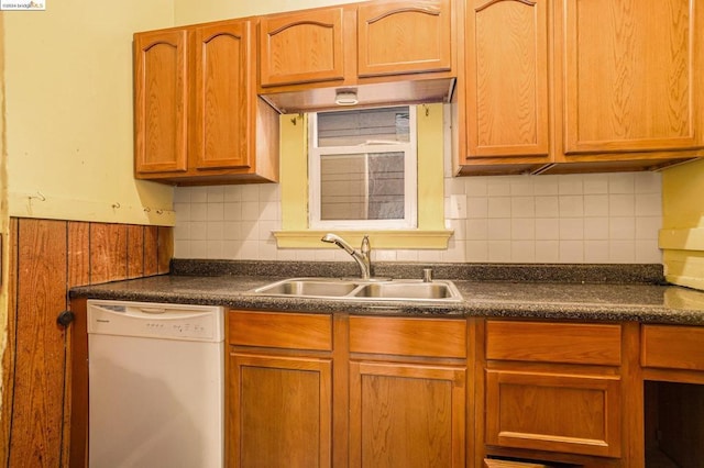 kitchen with backsplash, white dishwasher, and sink