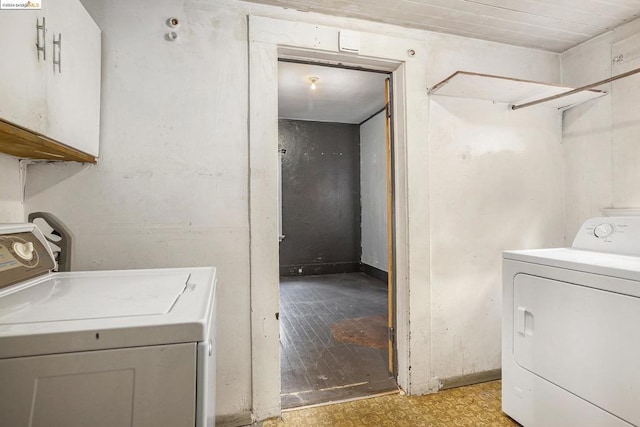 laundry area with cabinets and washing machine and clothes dryer