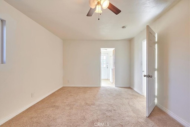 unfurnished room featuring light carpet and ceiling fan